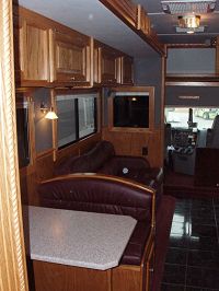 Living Area w/driver side slide-out sofa bed & dinette in burgandy upholstery