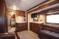 Living Area & Kitchen w/slideout, dark oak cabinetry & burgandy upholstery